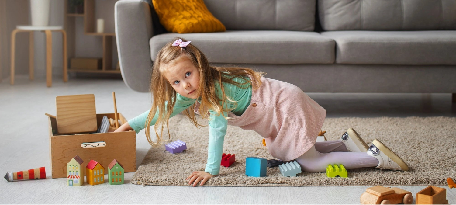 Child playing with toys on the floor in a living room